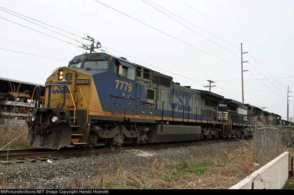 CSX 7779 is in the lead of NS train 349, parked north of the yard